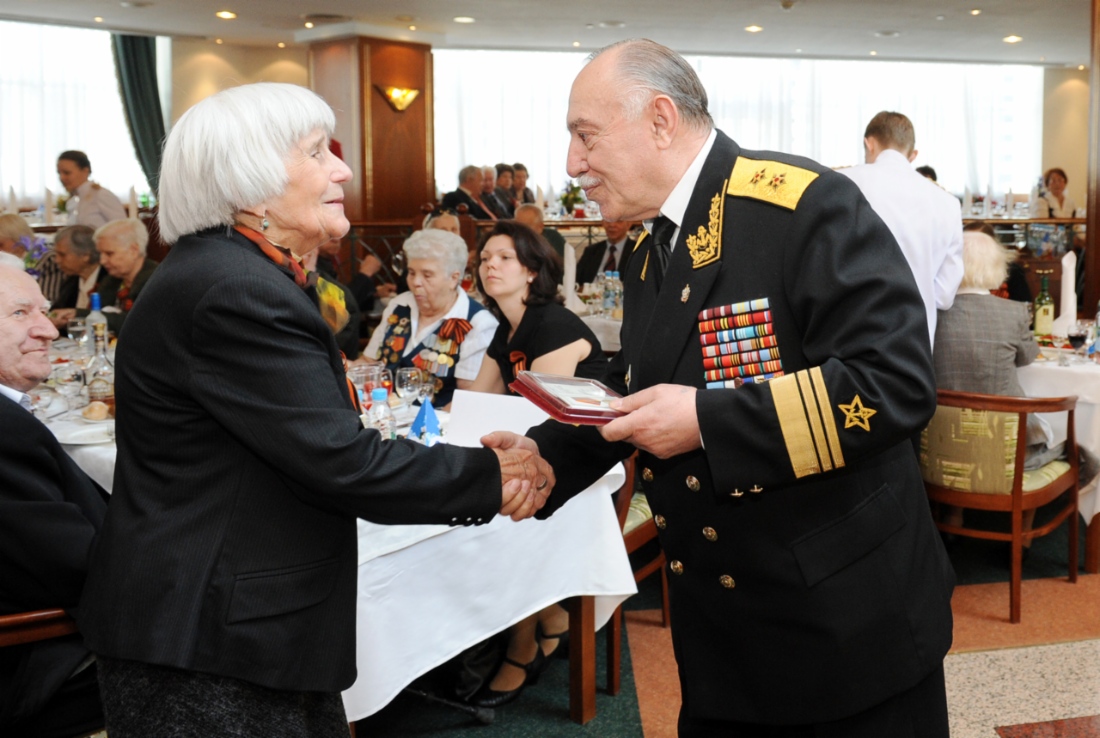 Bagrat Knyazchan, committee deputy chairman of National Public Organization of War and Military Service Veterans hands memorable gift to Galina Gulyaeva, May 5, 2011